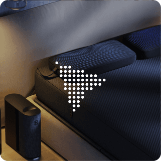 An Eight Sleep Pod beside a bed